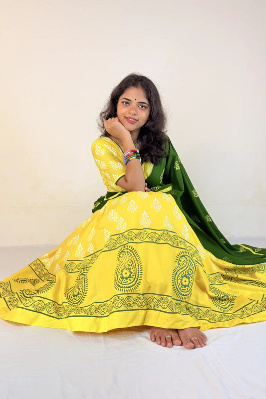 Woman wearing a yellow and green traditional outfit on a white background