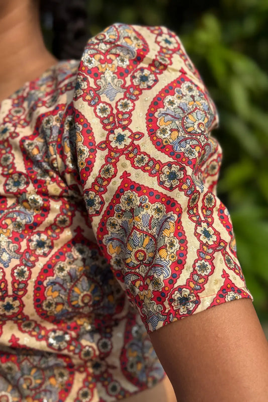 Close-up of short sleeve on cotton paisley block print blouse, showcasing fabric texture and print detail