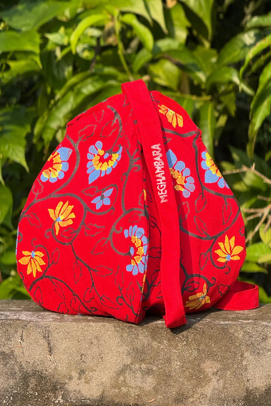 Red handcrafted cotton japa mala bag featuring floral block print design and structured shape, eco-friendly spiritual accessory