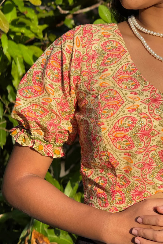Model wearing Meghambara Surangini hand-printed cotton blouse with puff sleeves and traditional folk motifs
