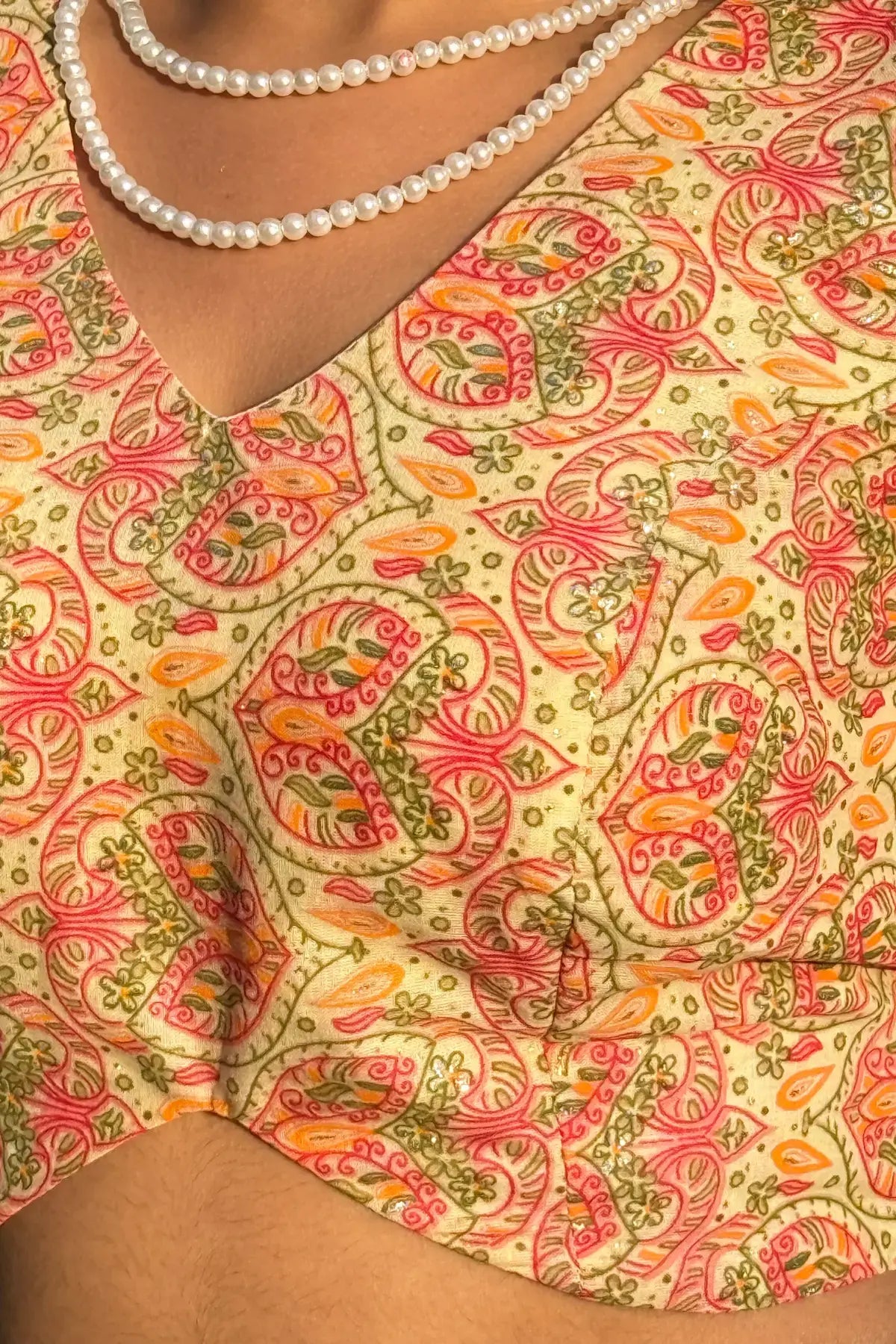 Close-up view of Meghambara Surangini cotton blouse showcasing hand-printed folk paisley motifs and V-neckline detail