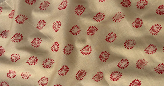 Off-white fabric with red alpana-inspired kalka motif hand block print pattern by Meghambara