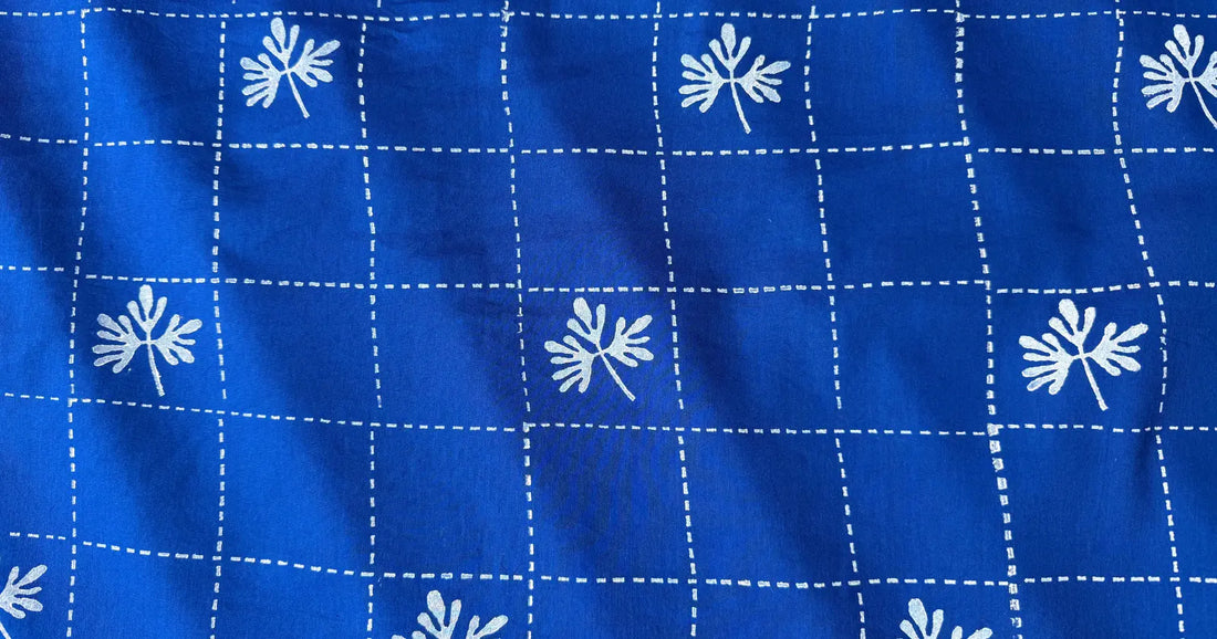 Deep blue block print fabric with simple line grid pattern and white leaf motifs by Meghambara
