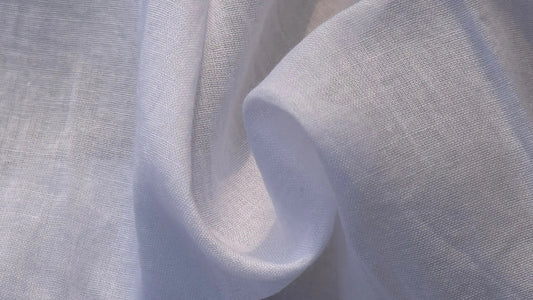 Close-up view of pure cotton fabric showing matte texture, natural weave, and breathable structure