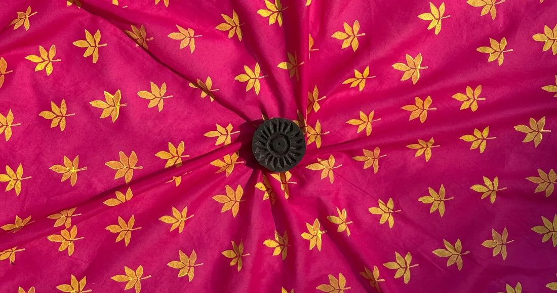 Close-up of a pink fabric with yellow floral patterns