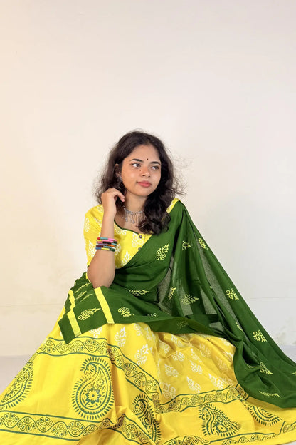 Woman wearing a yellow and green Gopi Skirt Set with a white background