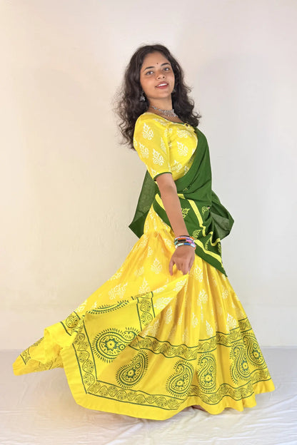 Woman wearing a yellow and green traditional outfit on a white background