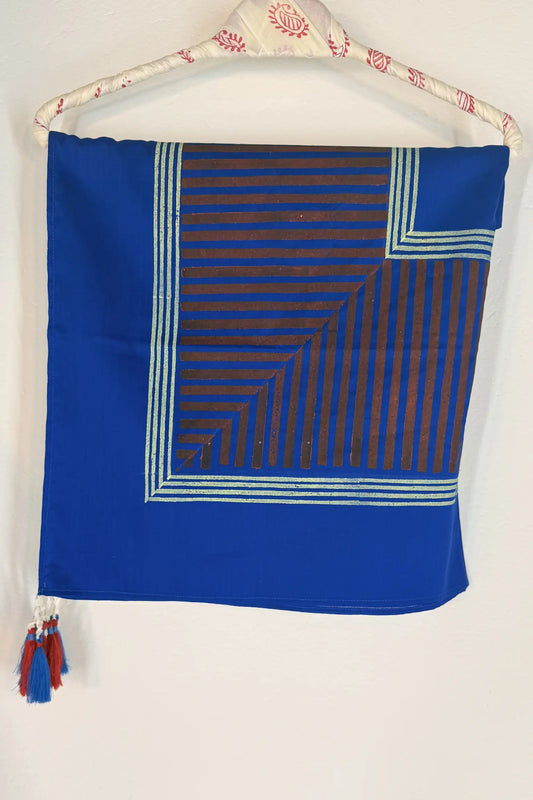 Blue cotton scarf with geometric block print in brown and gold, featuring fine line detailing and handcrafted tassels