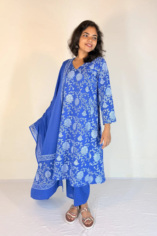 Woman wearing a blue embroidered kurta with matching dupatta on a white background