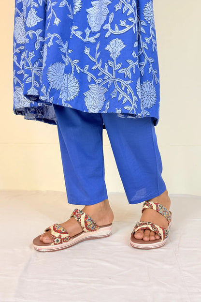 Blue floral outfit with matching pants and sandals on a white background