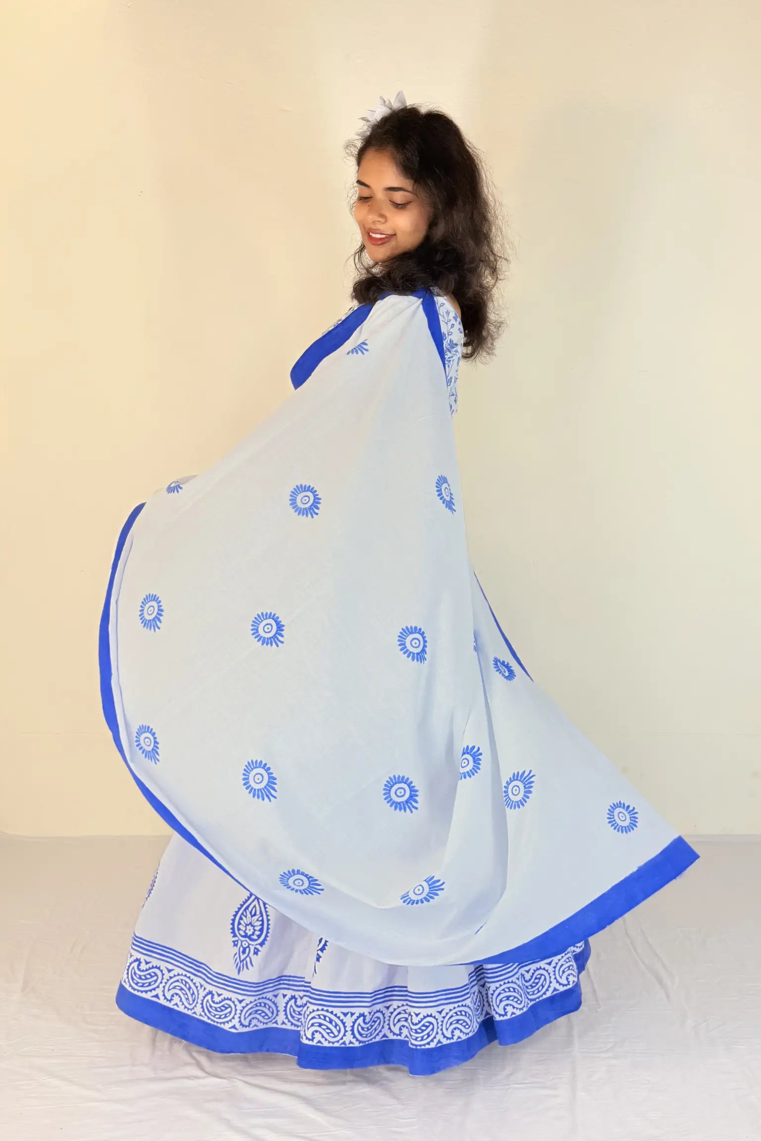 Woman wearing a purple Gopi Dress with white patterns against a plain background