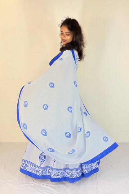 Woman wearing a purple Gopi Dress with white patterns against a plain background