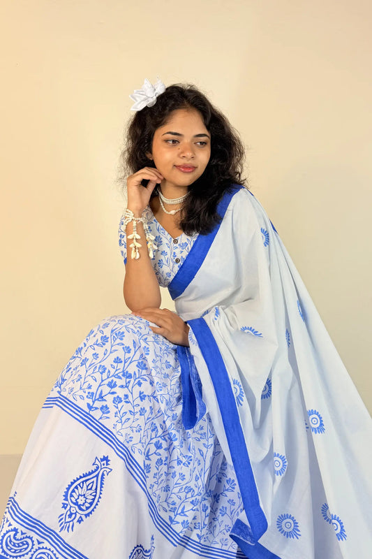 Woman wearing a purple Gopi Dress with white patterns on a plain background