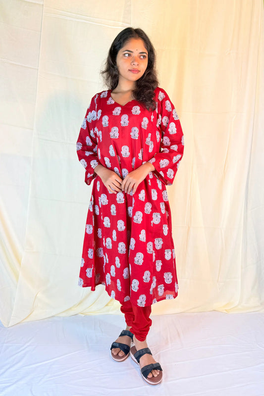 Woman wearing a red floral dress against a white background