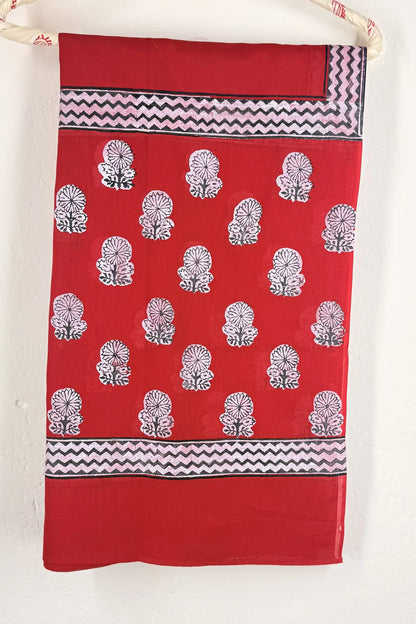 Red towel with black and white patterns hanging on a rack