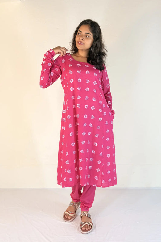 Woman wearing a pink floral outfit on a white background