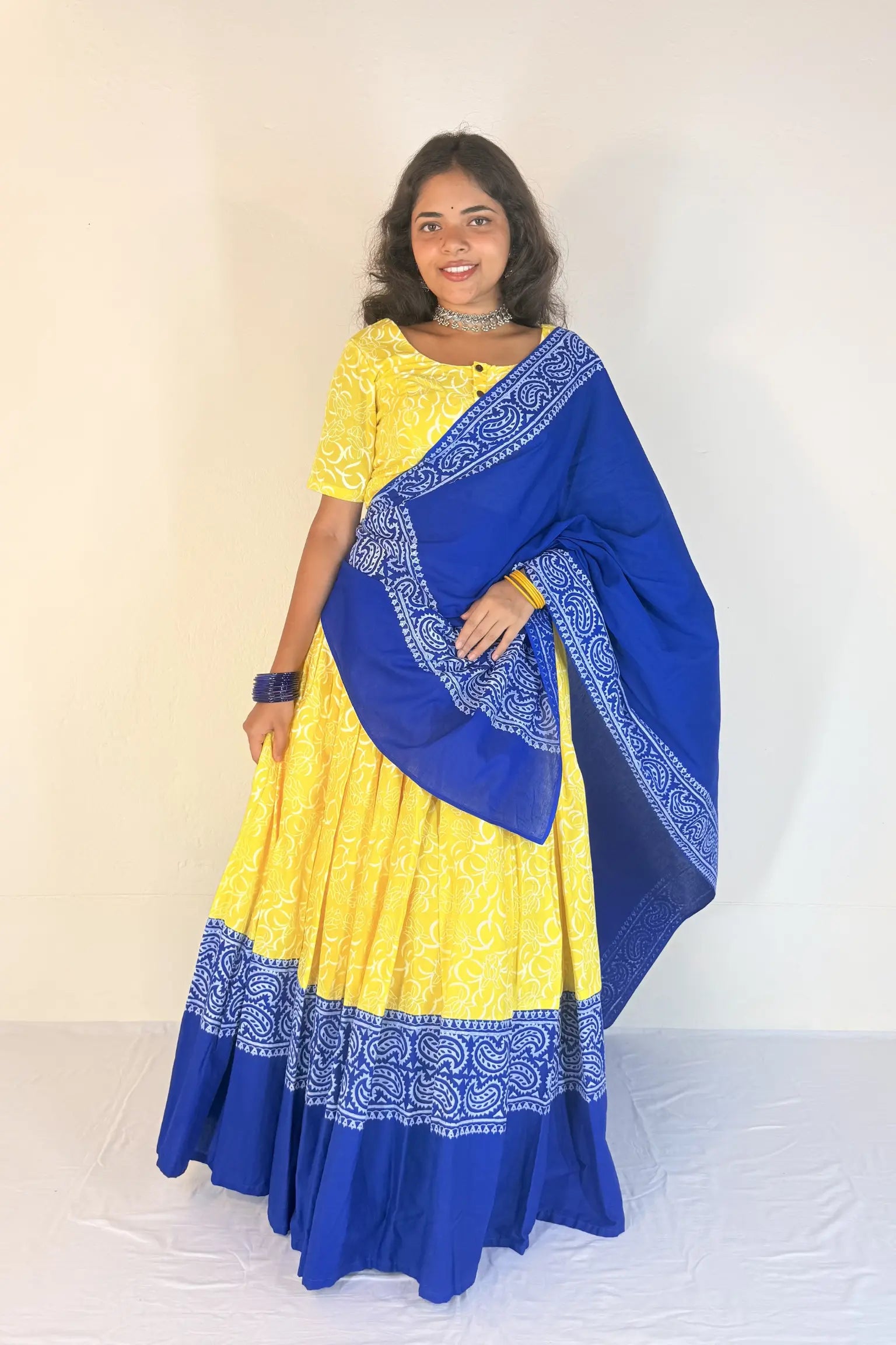 Woman wearing a yellow and blue Gopi Skirt Set against a white background