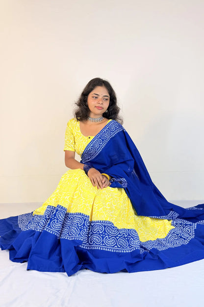 Woman wearing a yellow and blue traditional outfit with a white background