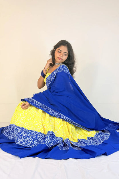 Woman wearing a blue and yellow traditional outfit with a white background