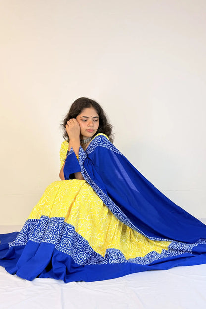 Woman wearing a blue and yellow traditional outfit with a white background