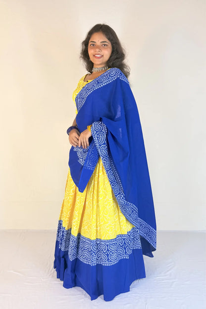 Woman wearing a blue and yellow Gopi Skirt Set with a white background