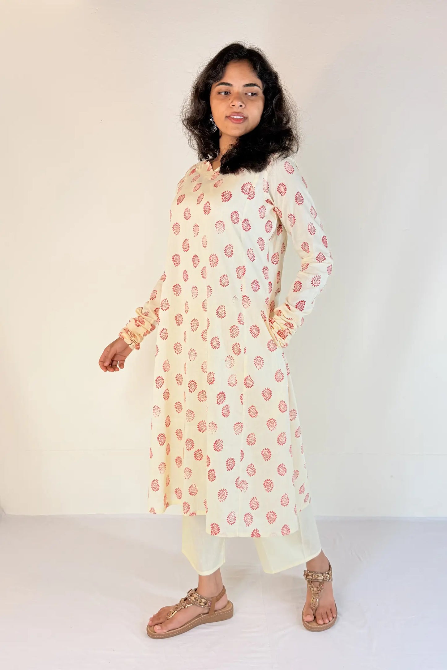 Woman wearing a white floral kurta against a white background