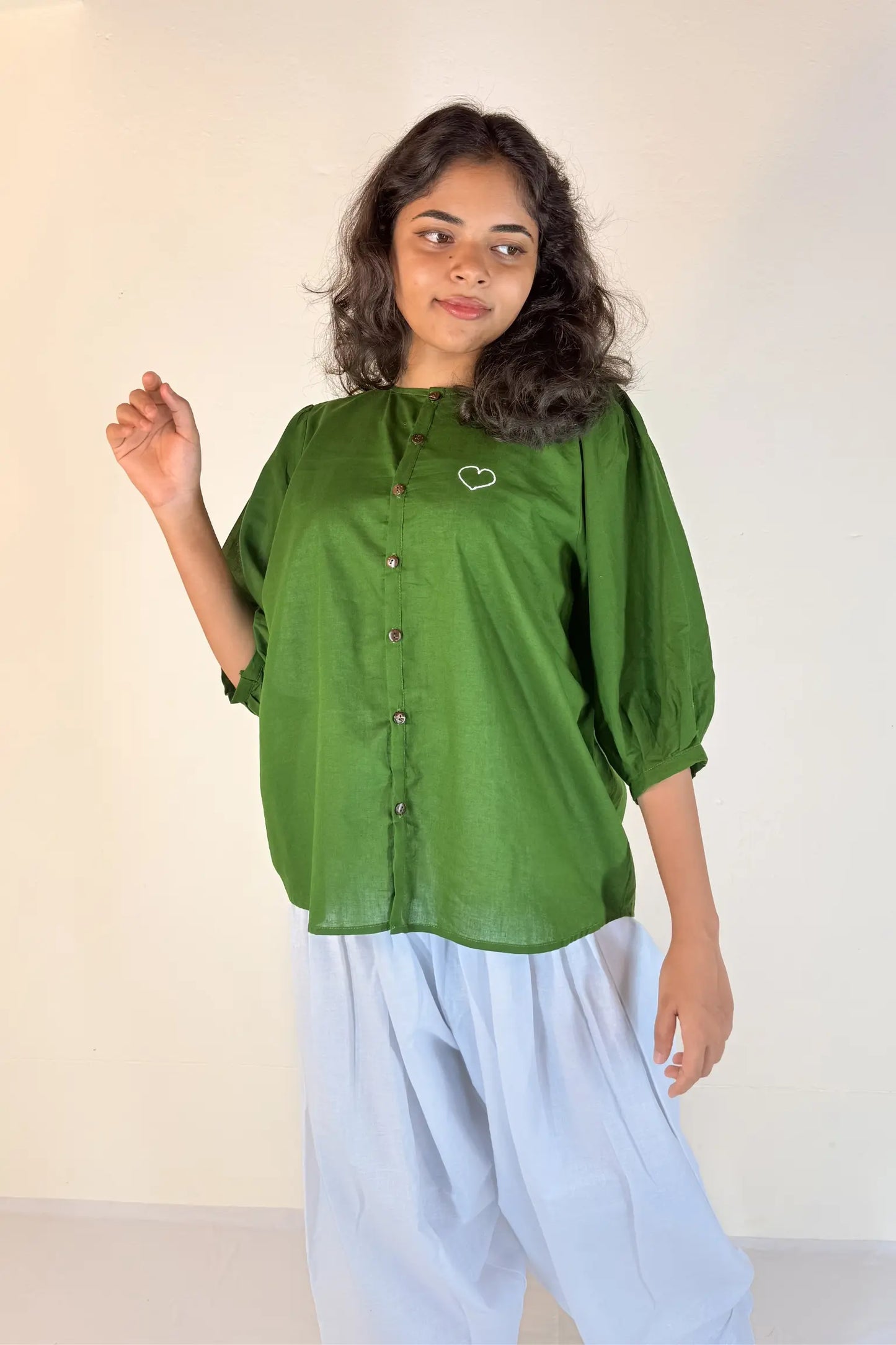 Woman wearing a green blouse with a white background