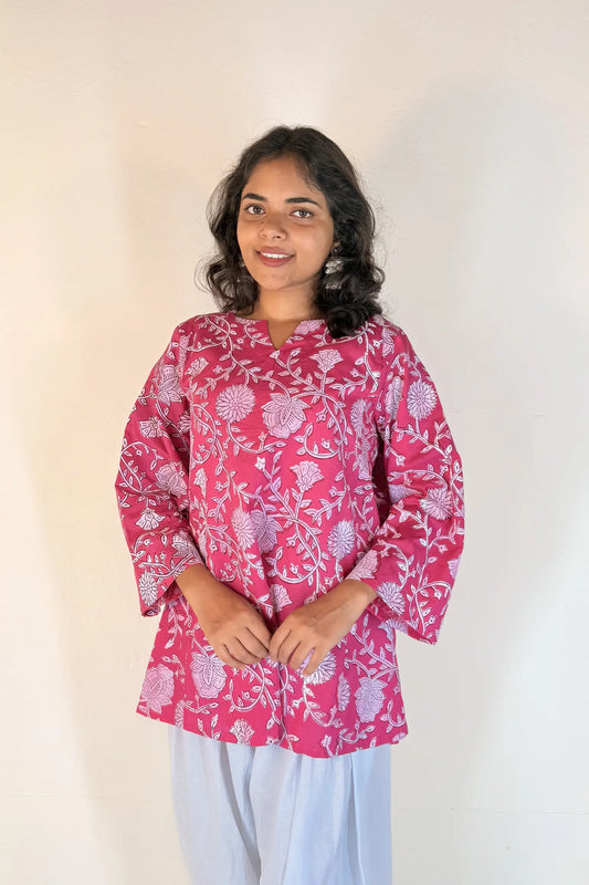 Woman wearing a red patterned dress against a white background