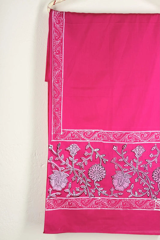 Pink fabric with white floral patterns on a white background