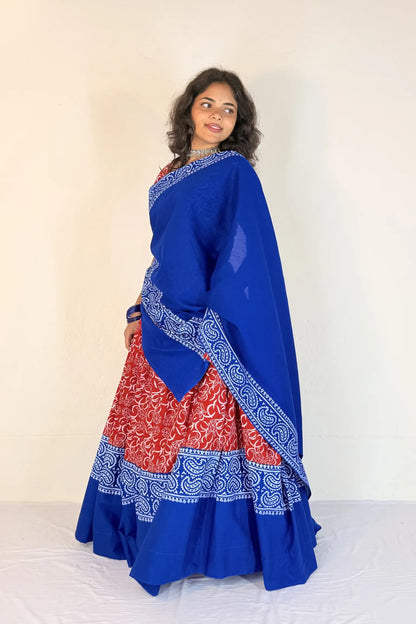 Woman wearing a blue and red traditional outfit with a white background