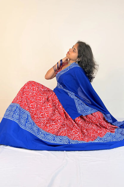 Woman wearing a blue and red traditional outfit with a white background
