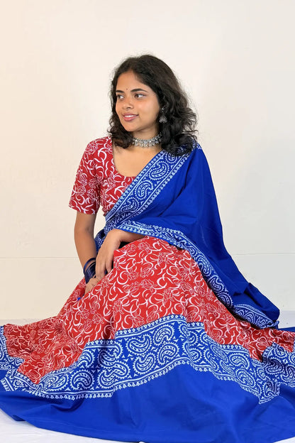 Woman wearing a red and blue Gopi Dress with a white background