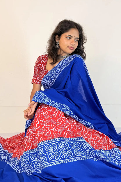 Woman wearing a blue and red traditional outfit with a white background