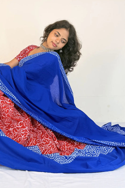 Woman wearing a blue and red traditional outfit with a white background