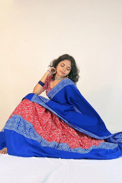 Woman wearing a blue and red traditional outfit with a white background