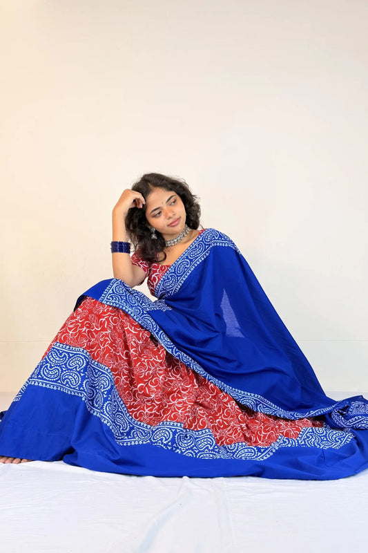 Woman wearing a blue and red traditional outfit with a white background