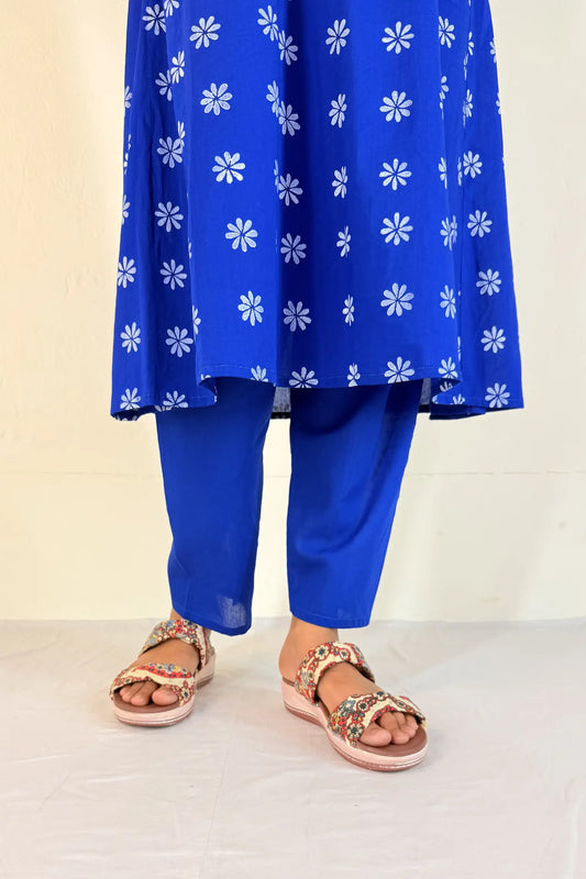 Blue outfit with white floral patterns on a plain background