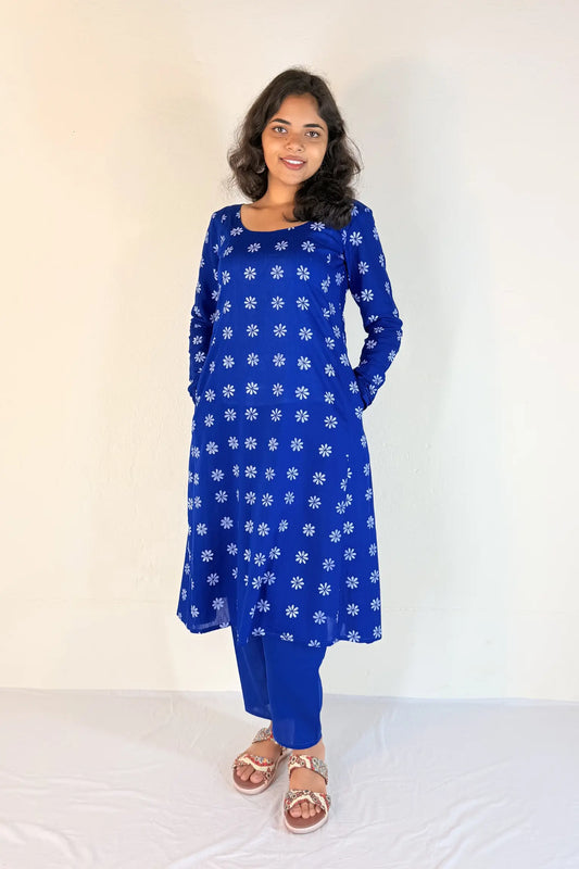 Woman wearing a blue floral dress against a white background