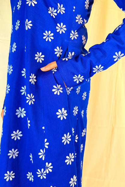 Blue dress with white floral pattern on a yellow background