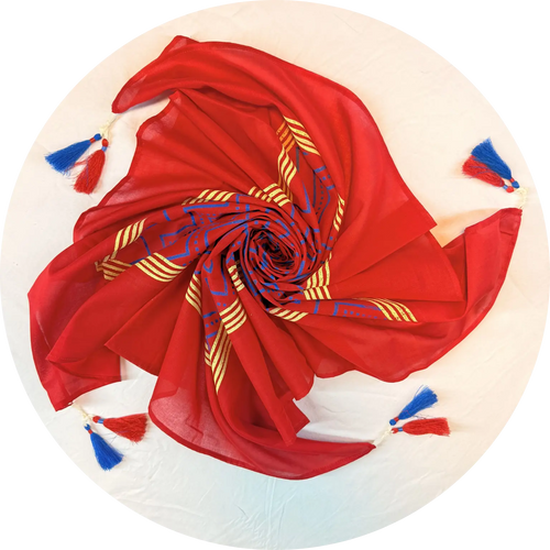 Red scarf with blue and gold patterns on a beige background