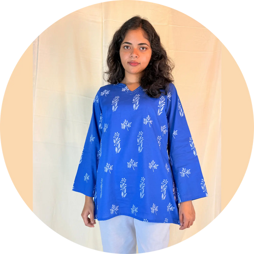 Woman wearing a blue floral patterned top against a beige background