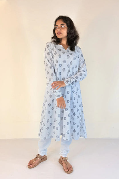 Woman wearing a light blue kurta with a subtle pattern against a white background