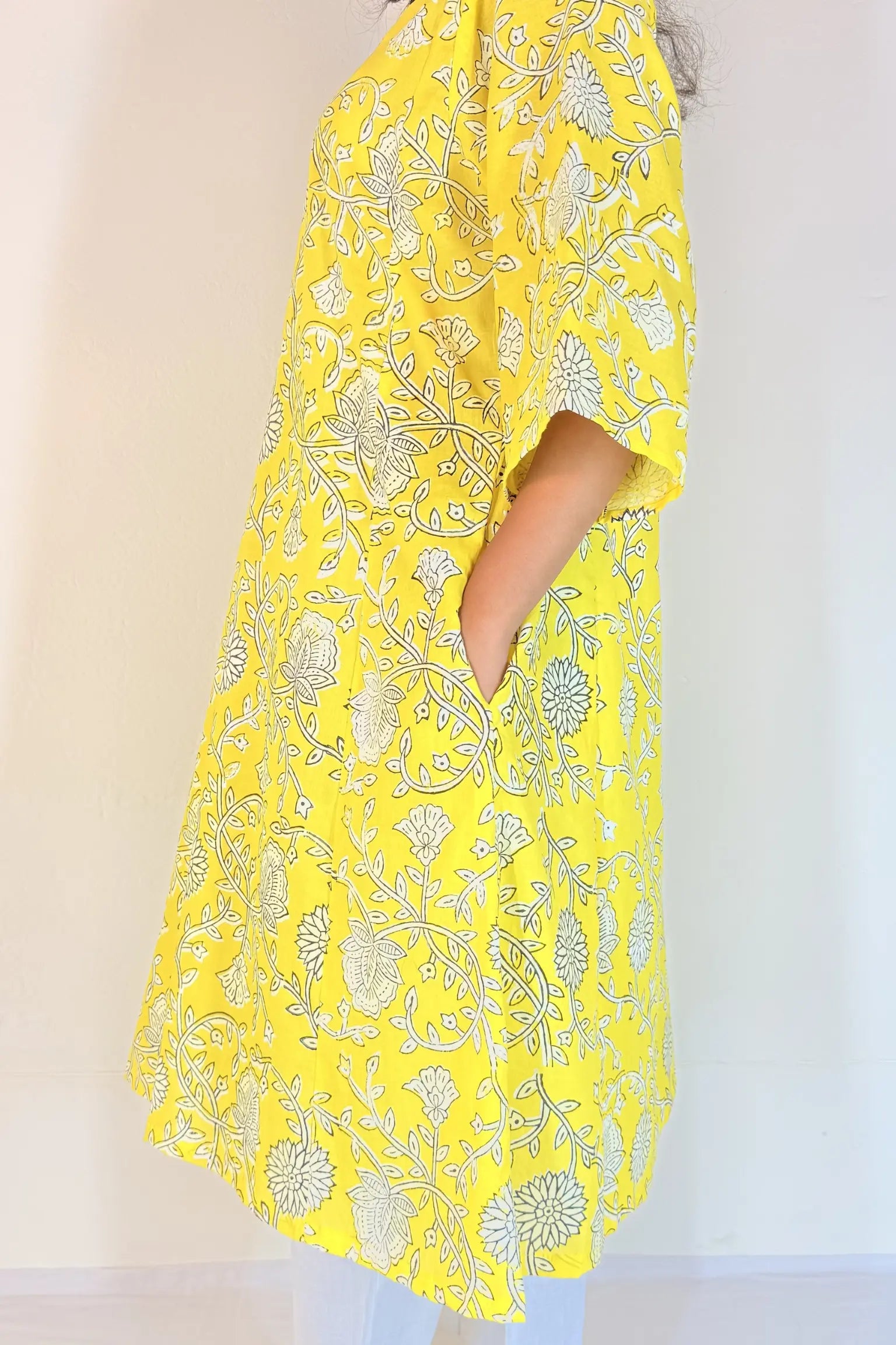 Yellow floral patterned kimono-style garment on a plain background