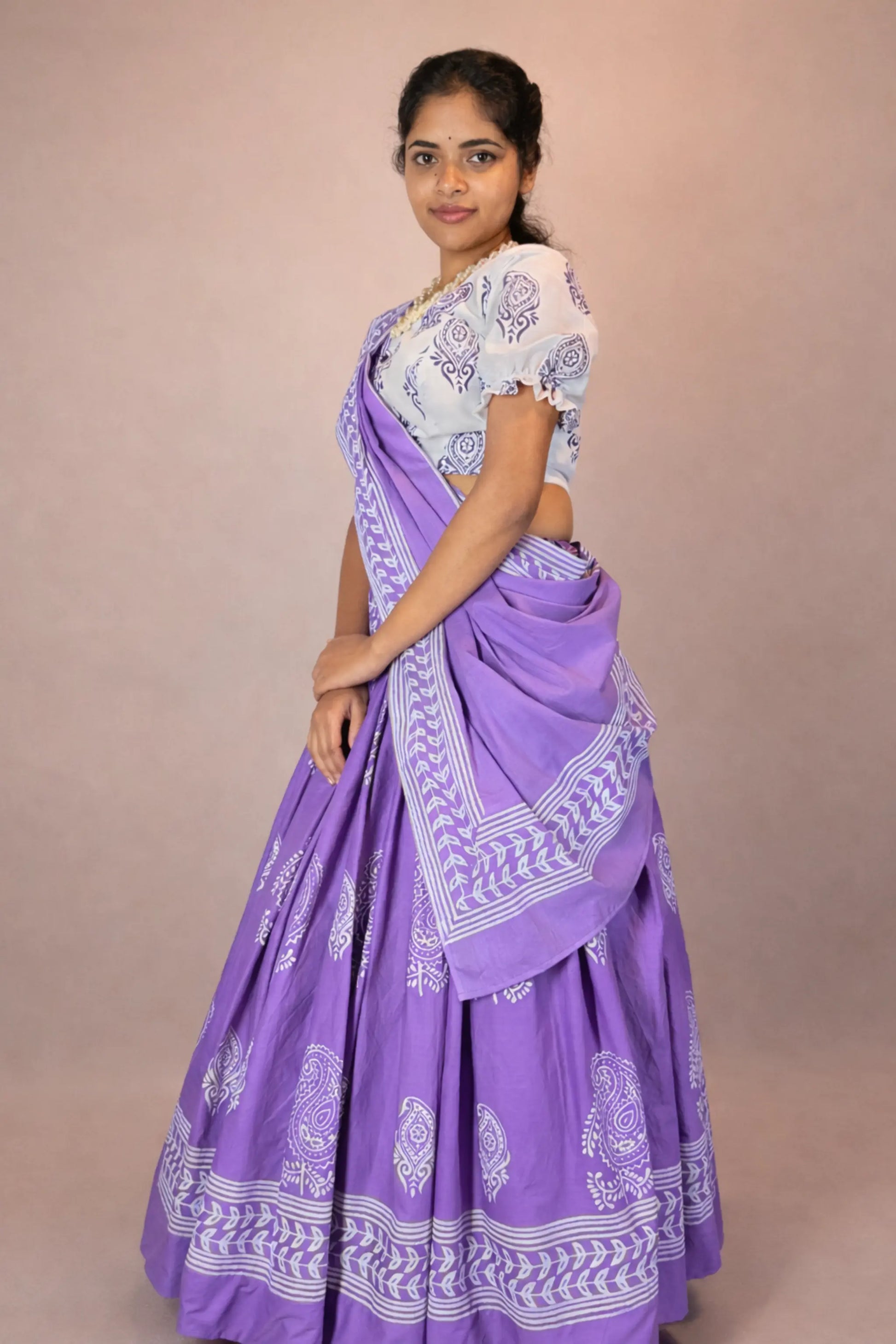 Full-length side view of Anuragini purple hand block printed pure cotton Gopi skirt set showing skirt flare