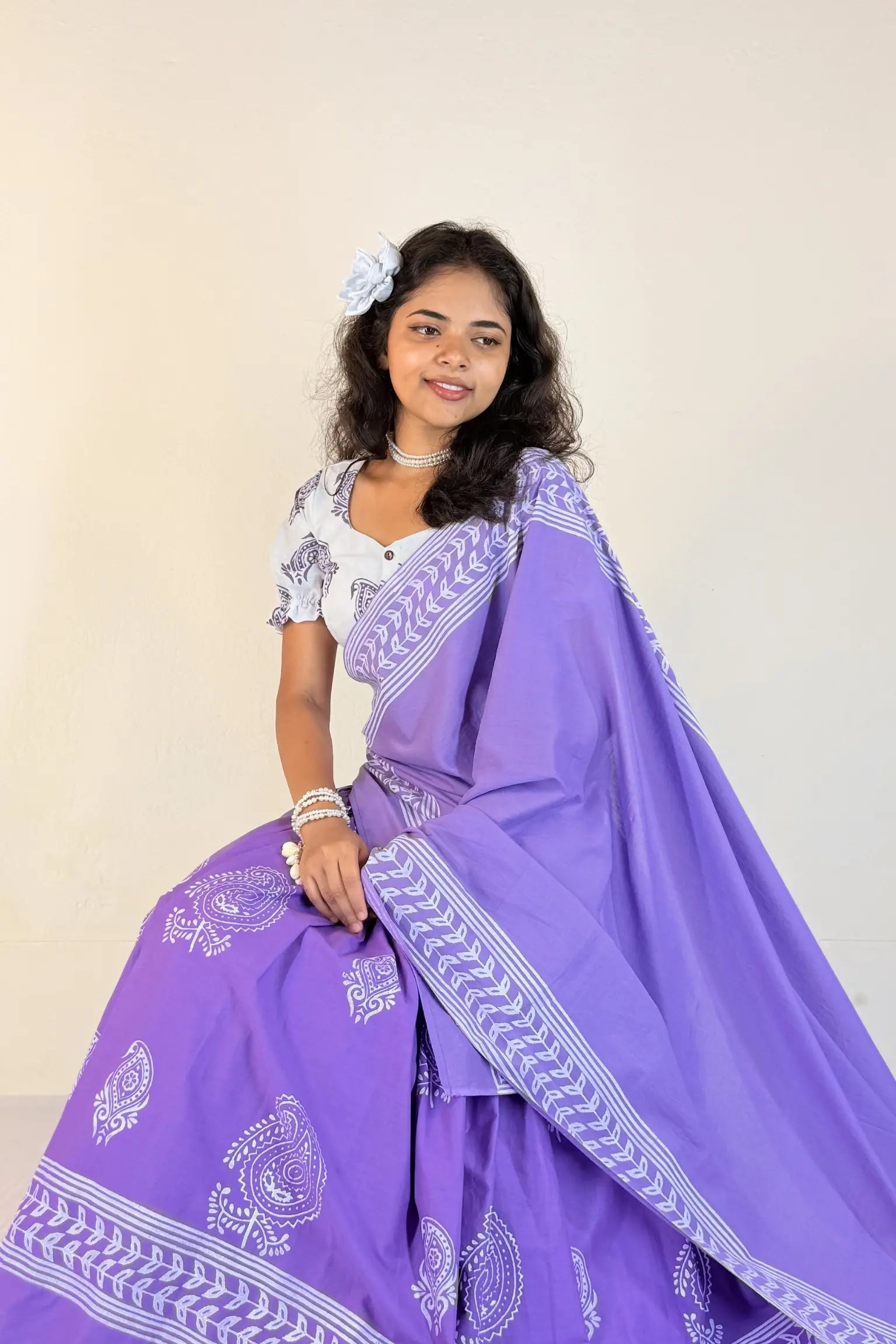 Woman wearing a purple Gopi Skirt Set with white patterns against a plain background
