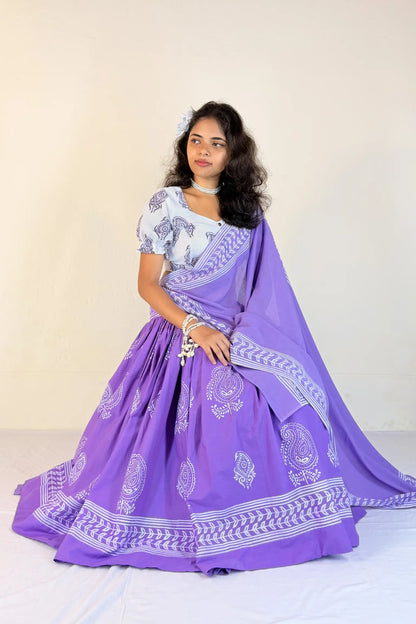 Woman wearing a purple Gopi Skirt Set with white patterns on a plain background