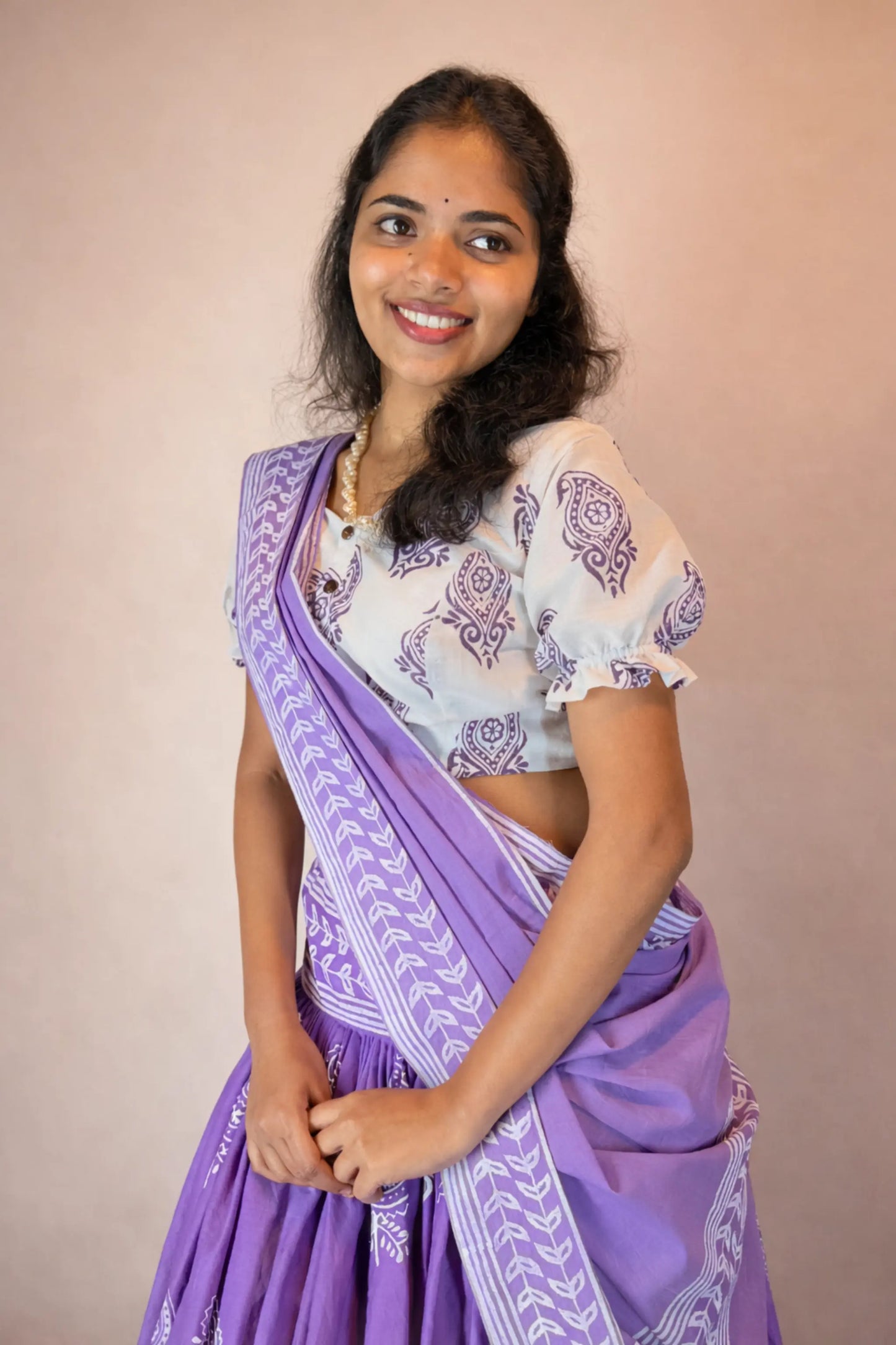 Smiling lifestyle view of Anuragini purple hand block printed pure cotton Gopi skirt set