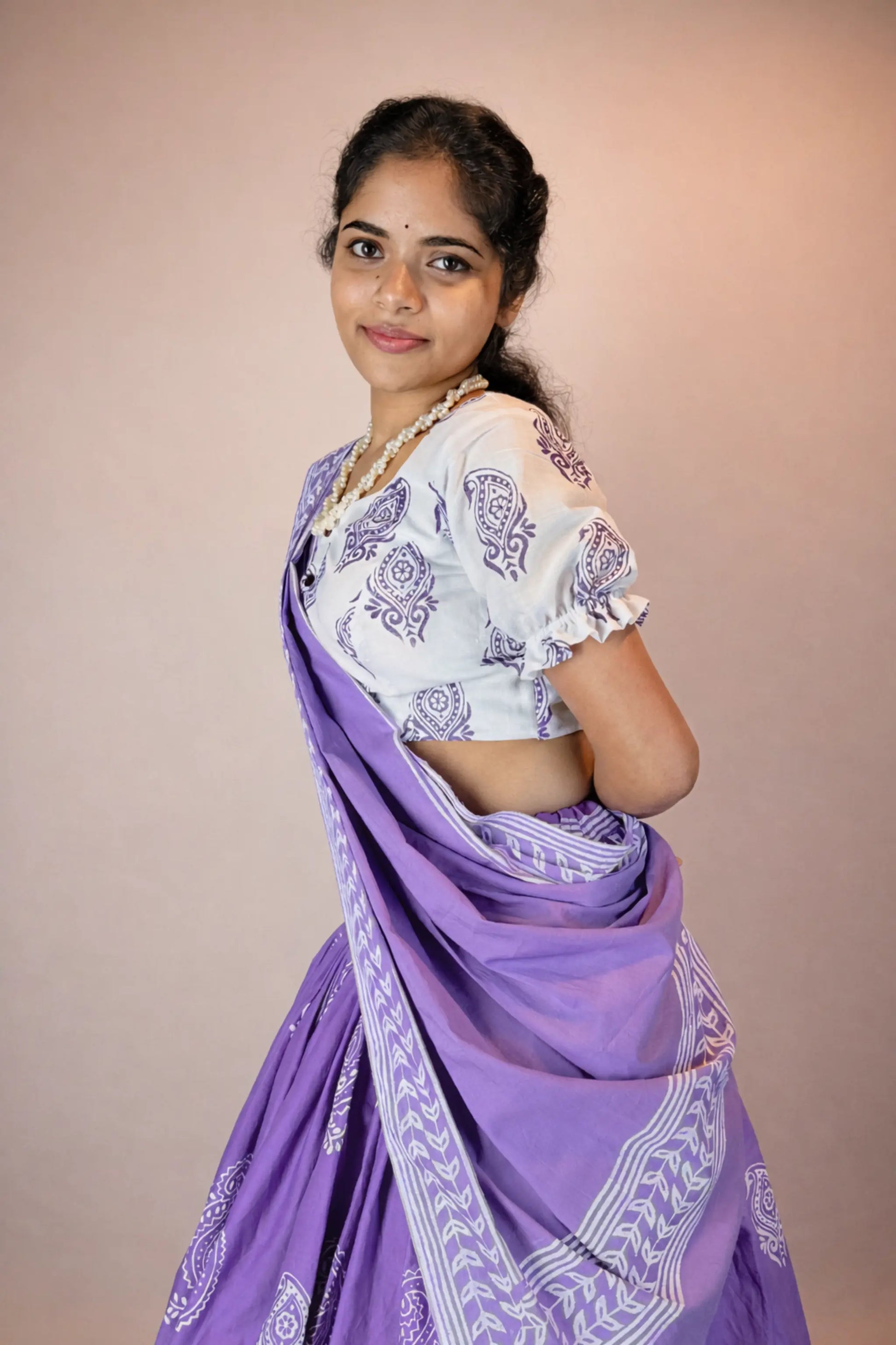 Three-quarter view of Anuragini purple hand block printed cotton Gopi skirt set styled for everyday wear