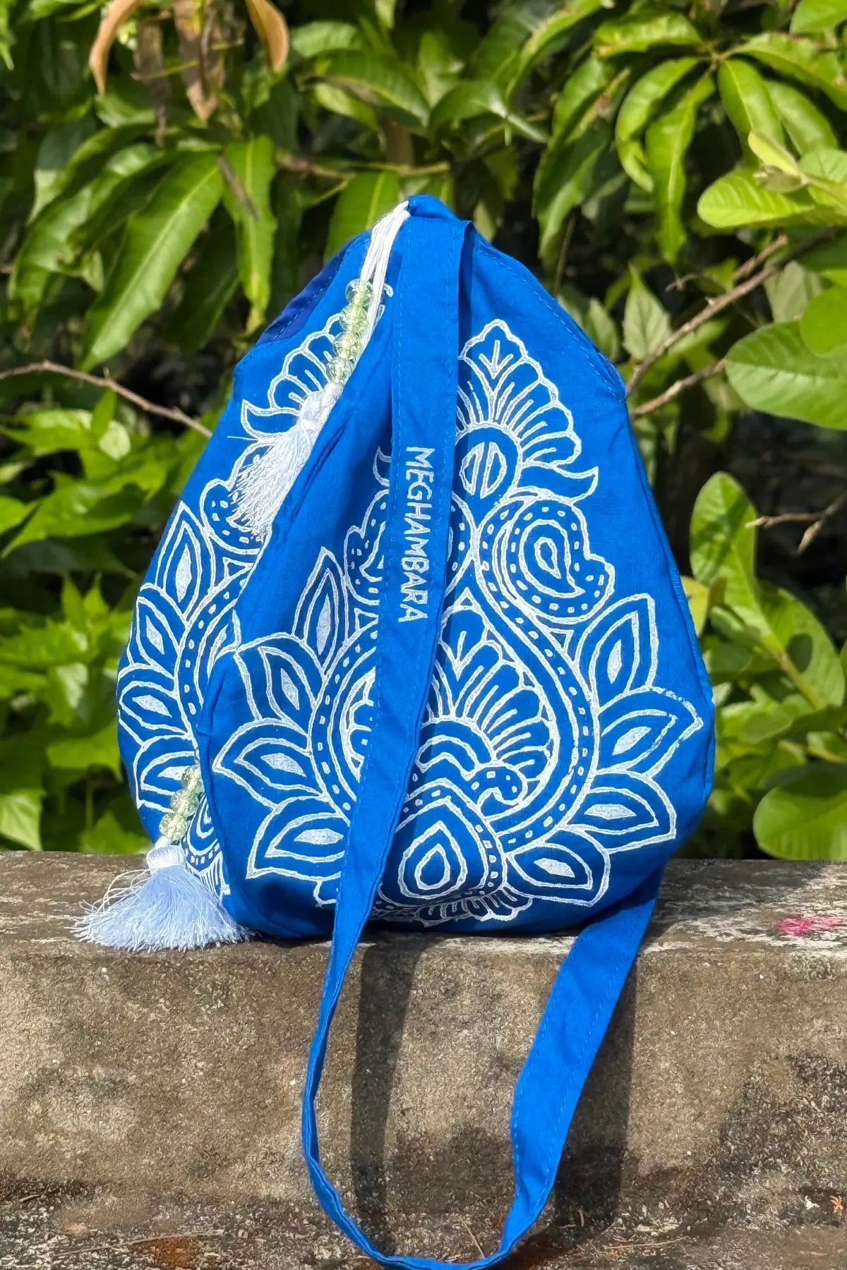 Indigo blue handcrafted japa mala bag with intricate white block printed design and drawstring closure, eco-friendly spiritual accessory