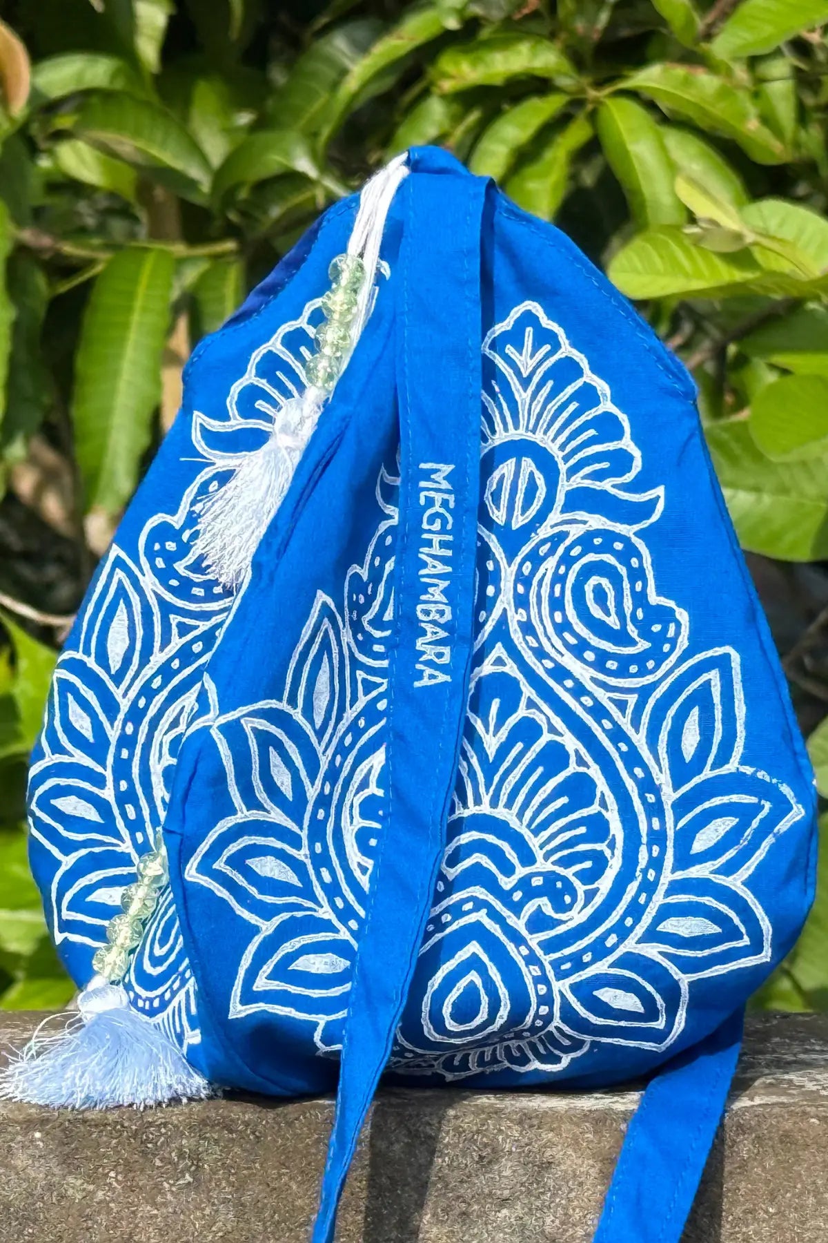 Indigo cotton japa mala bag featuring white hand block print and decorative japa mala beads, handmade by Meghambara